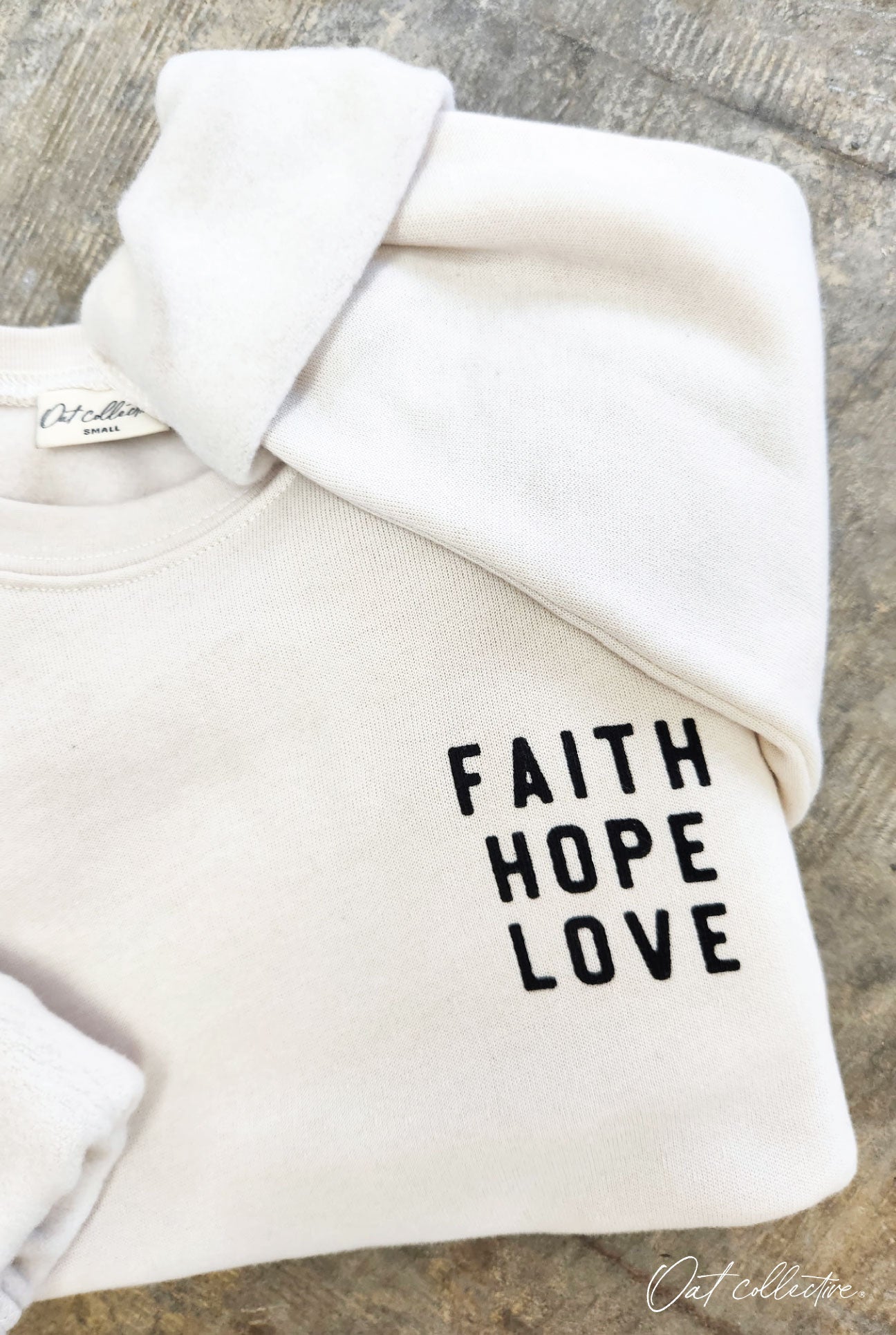 FRONT-FAITH HOPE LOVE BACK- BUT THE GREATEST OF THESE IS LOVE Fleece Pullover Relaxed Fit. Oat Collective