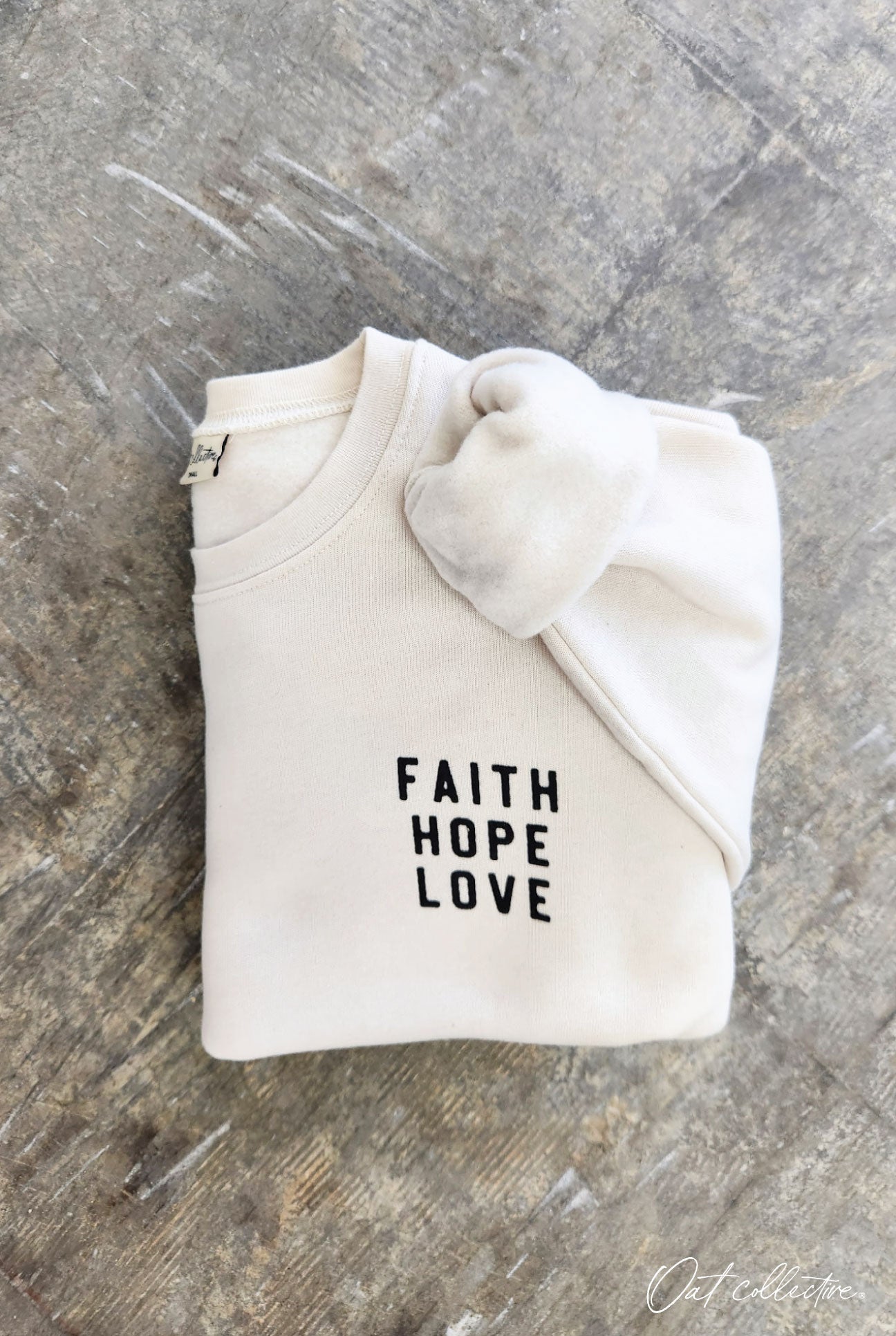 FRONT-FAITH HOPE LOVE BACK- BUT THE GREATEST OF THESE IS LOVE Fleece Pullover Relaxed Fit. Oat Collective